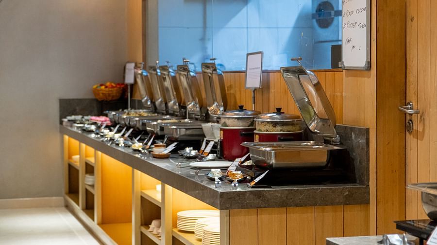 A buffet line with different food items in serving dishes.