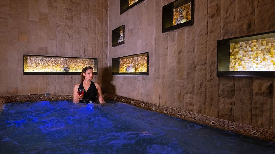 An image of a women inside a bathing tub -  The Manor Luxury Hotel, Shimla
