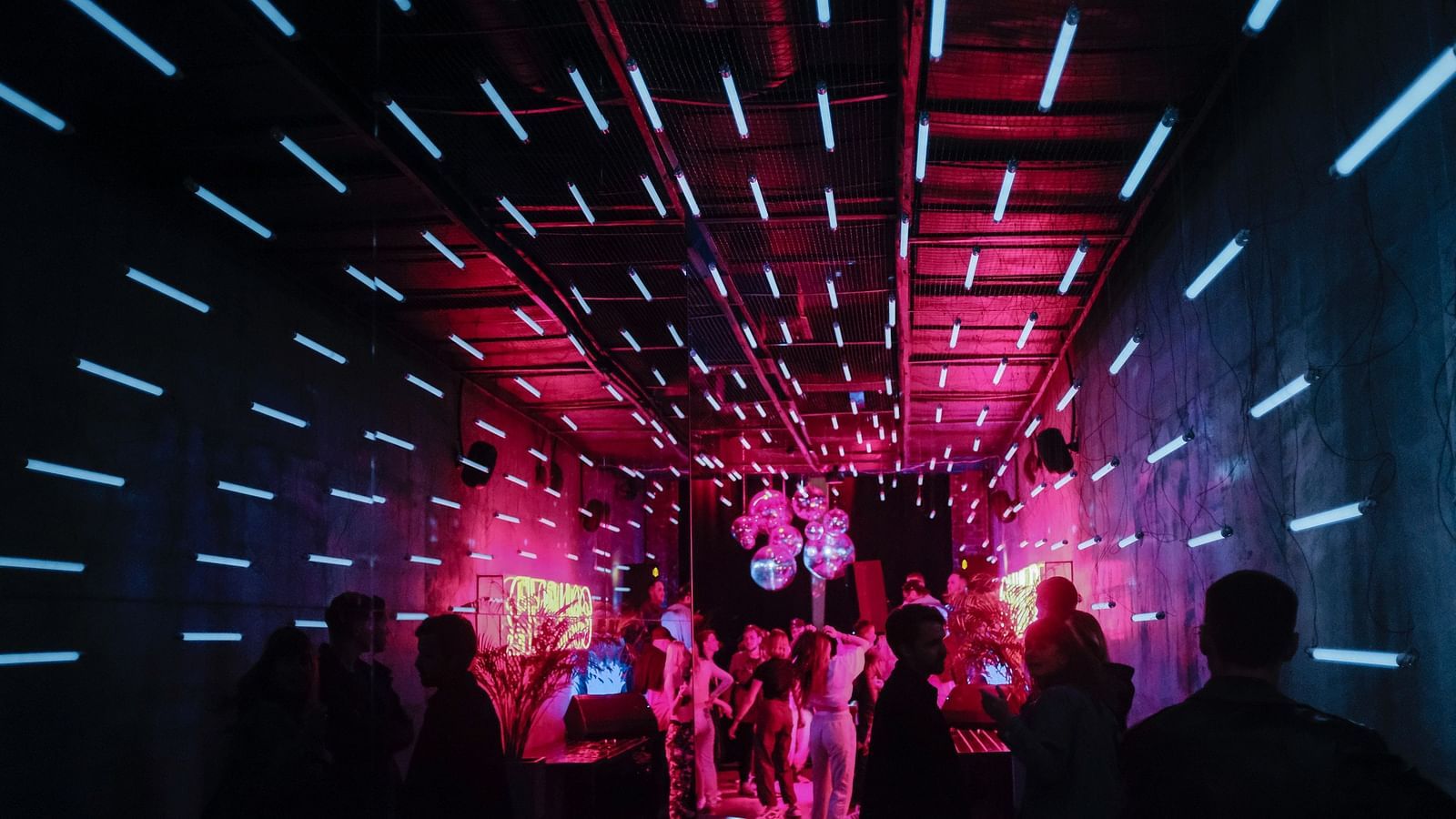 A club with neon lights and people