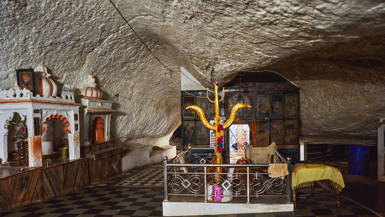 image of a temple site featuring a trishool in the middle