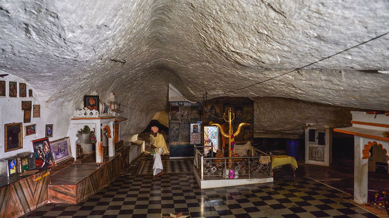 image of a pilgrim site constructed inside a cave with white coloured ceiling at the top