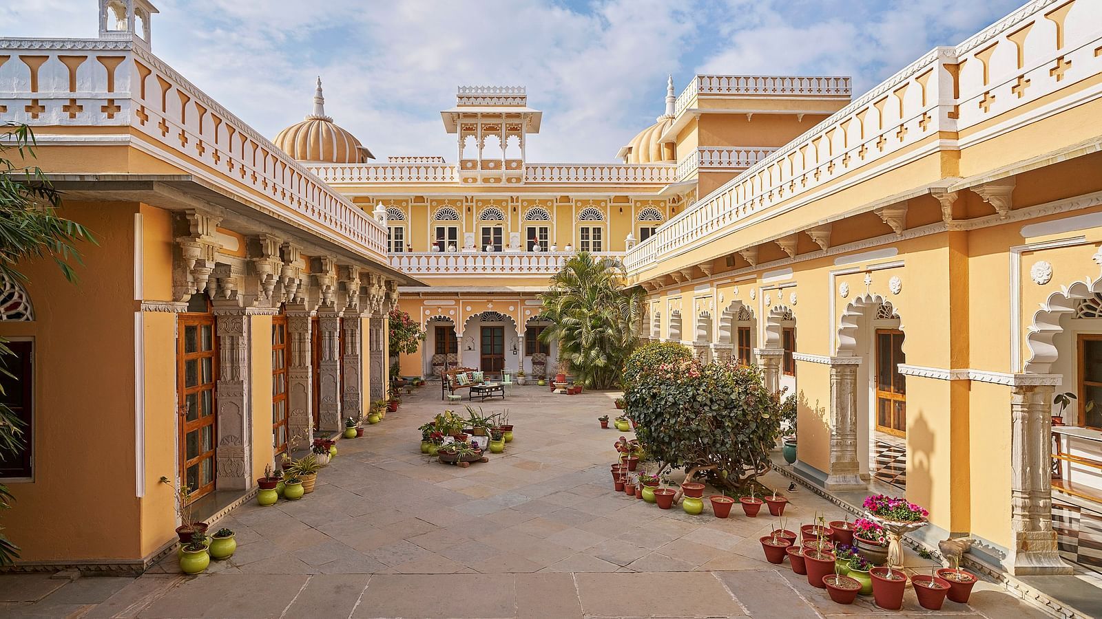 exterior image of dev shree, deogarh  with a beautiful sky with clouds in the background