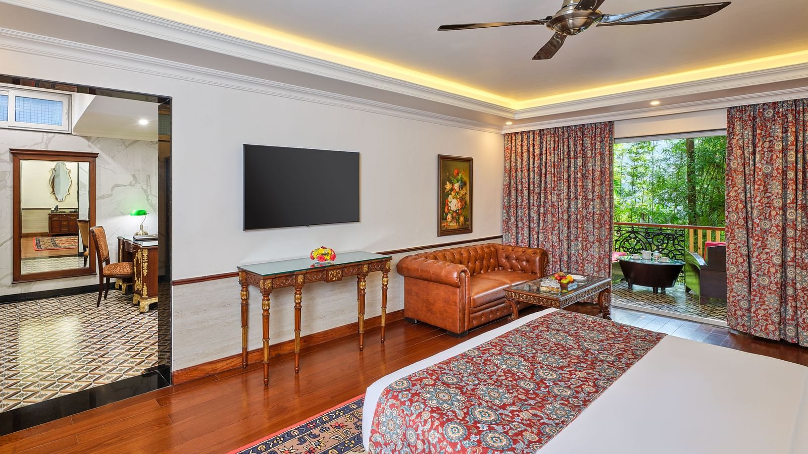 Premium Cottage bedroom with a comfortable bed, table, sofa, TV, a curtained balcony with a sitting area.