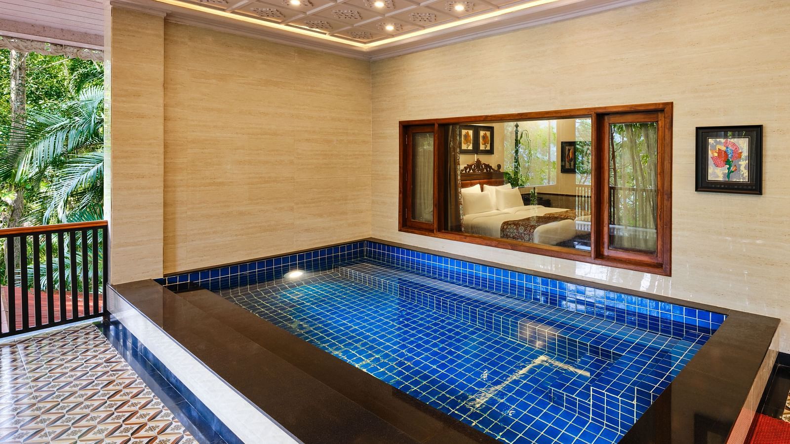 Regent villa's swimming pool with a window overlooking the bedroom at Mayfair spa resort and casino.