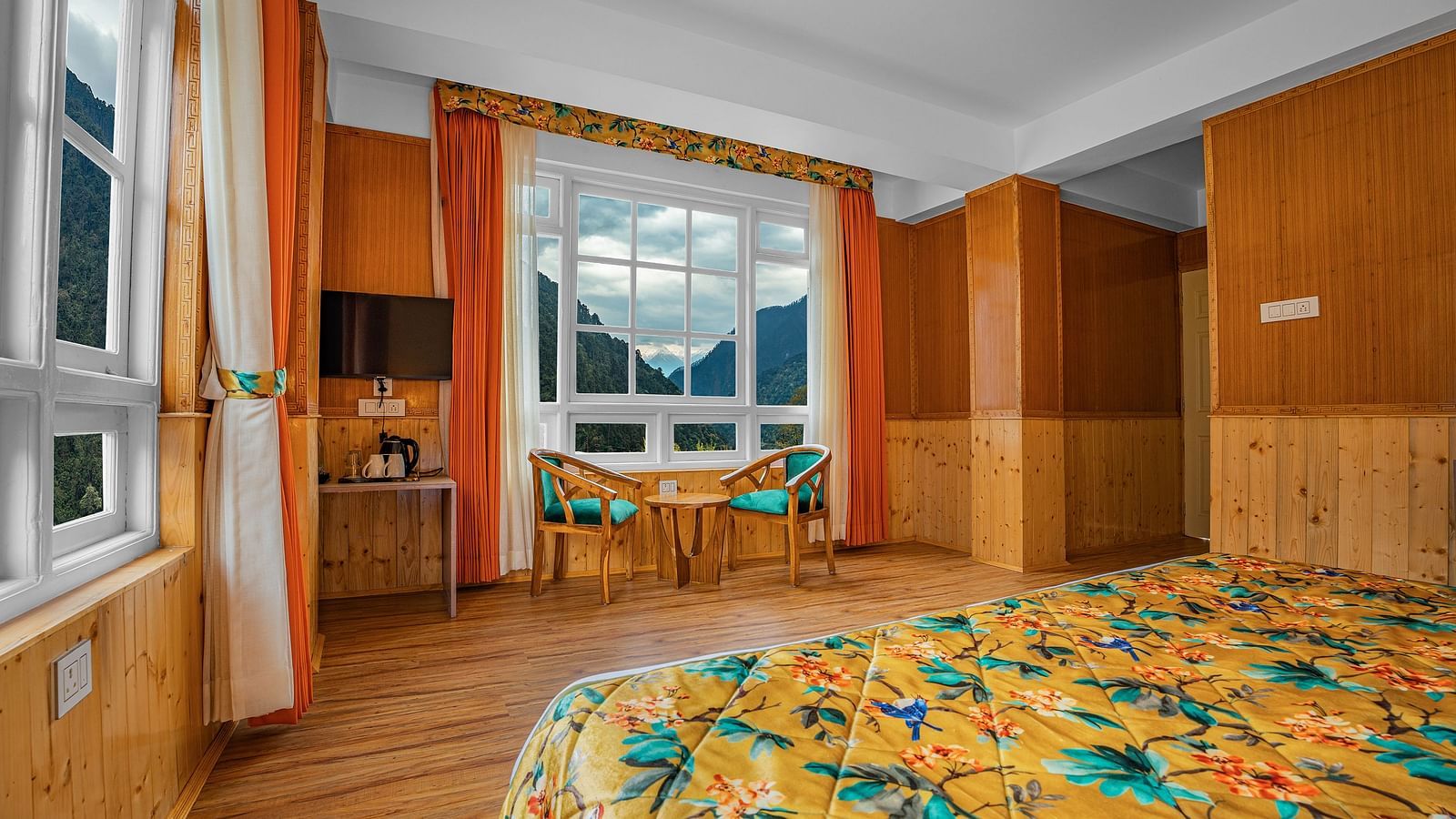 Image of a room with bed and television mounted on the wall at Summit Gangchen Hotel, Lachen
