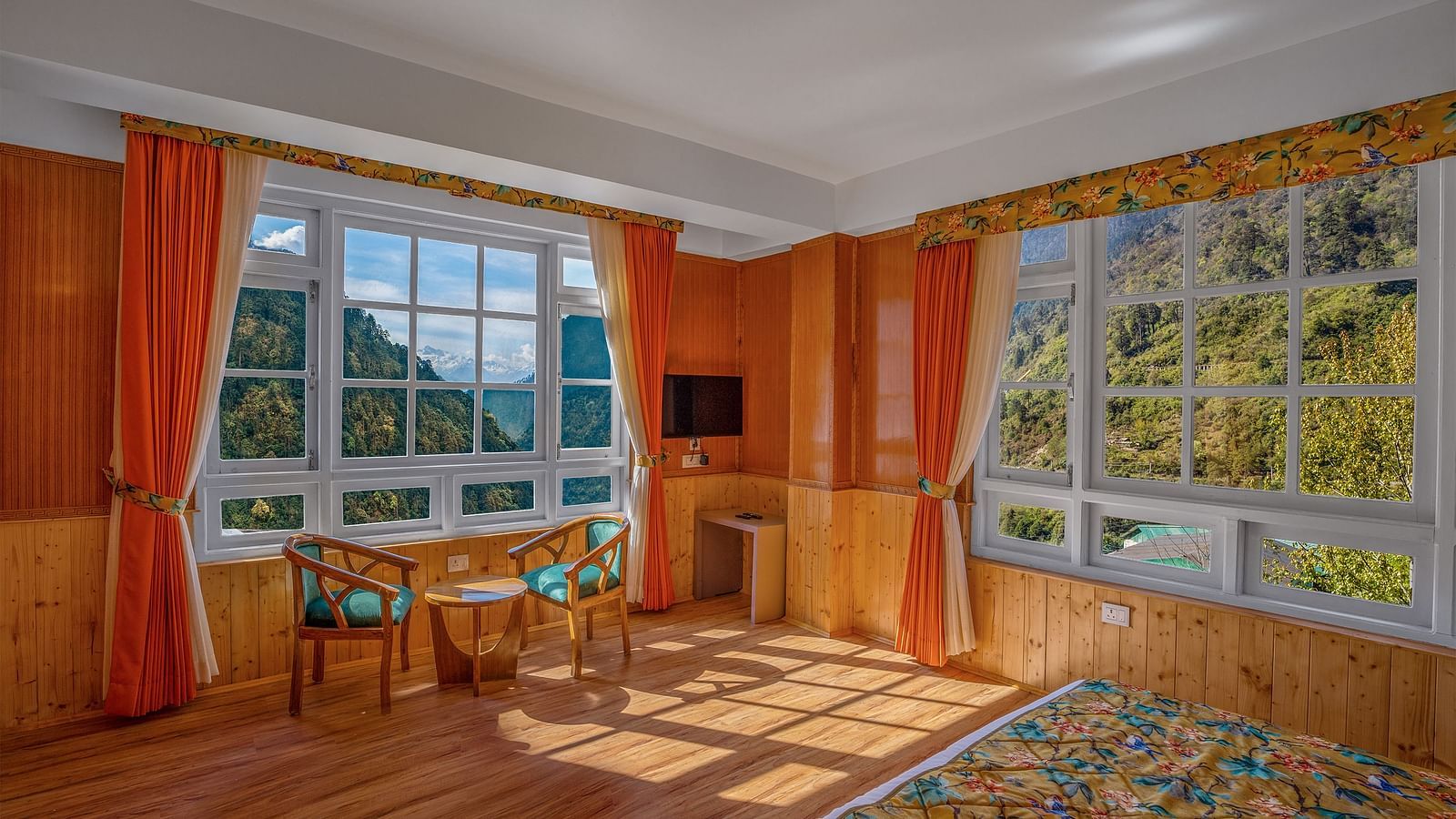 Image of a room with sitting area and windows on two sides at Summit Gangchen Hotel, Lachen