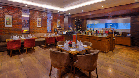 Shot of the interior of the restaurant featuring several chairs and tables.
