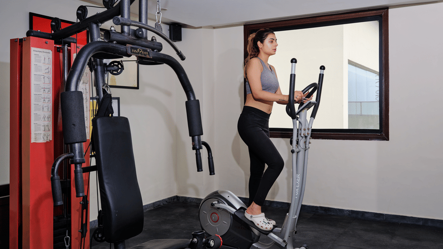 Image of a lady working out in the gym at the hotel.