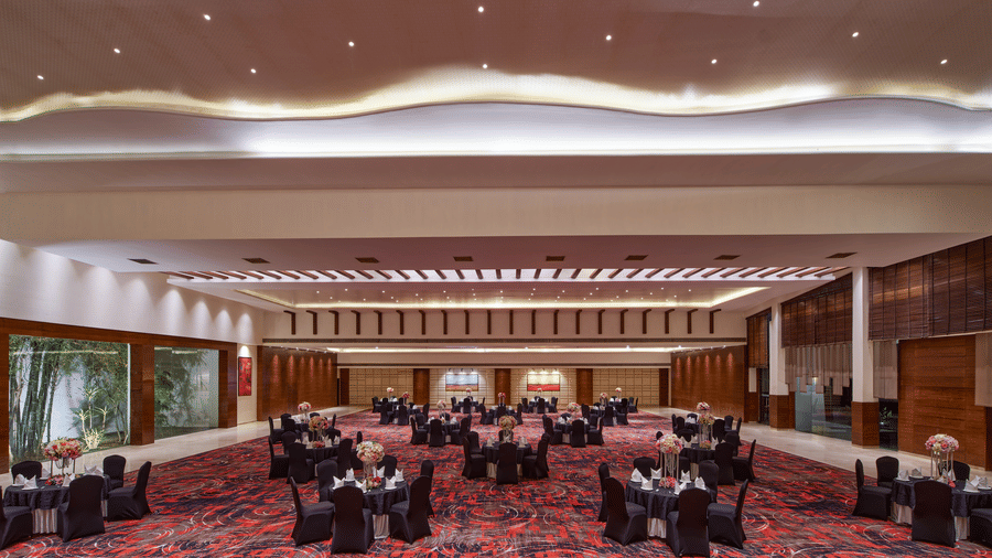 Image of an expansive banquet hall with different seating arrangements and carpeting.