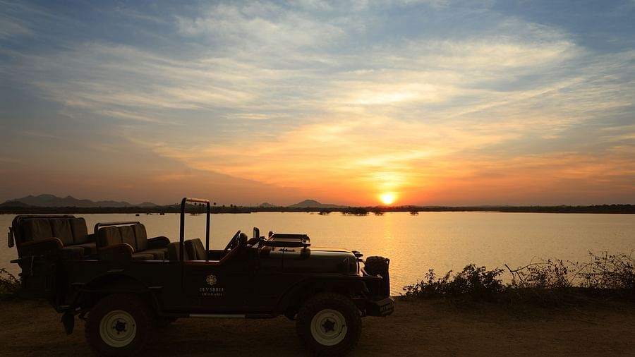 an image of a jeep with sunset in the background at dev shree, deogarh