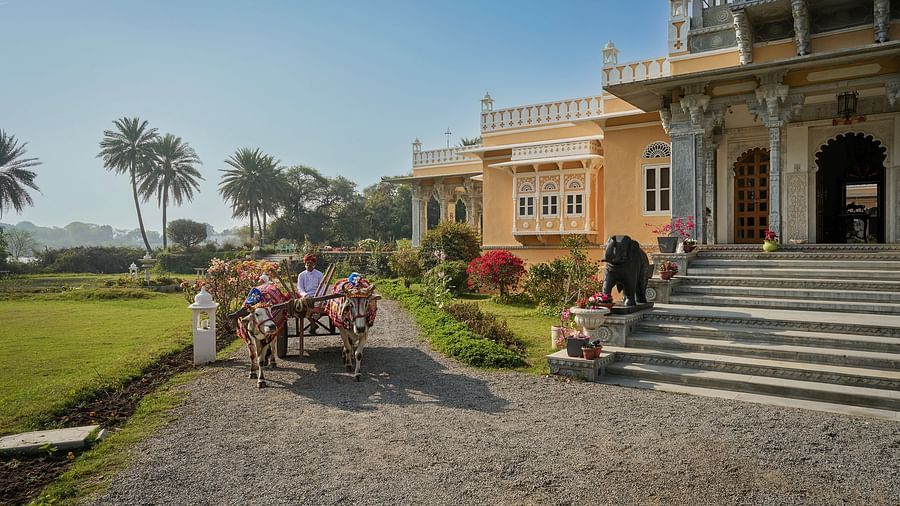 facade image of Dev Shree during the day with an outdoor seating area in the foreground