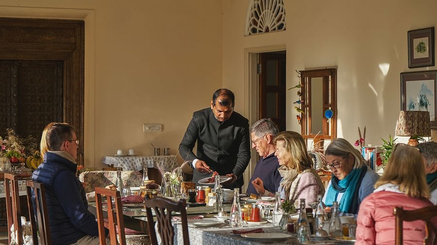 an image of people having food in the dining space at dev shree, deogarh