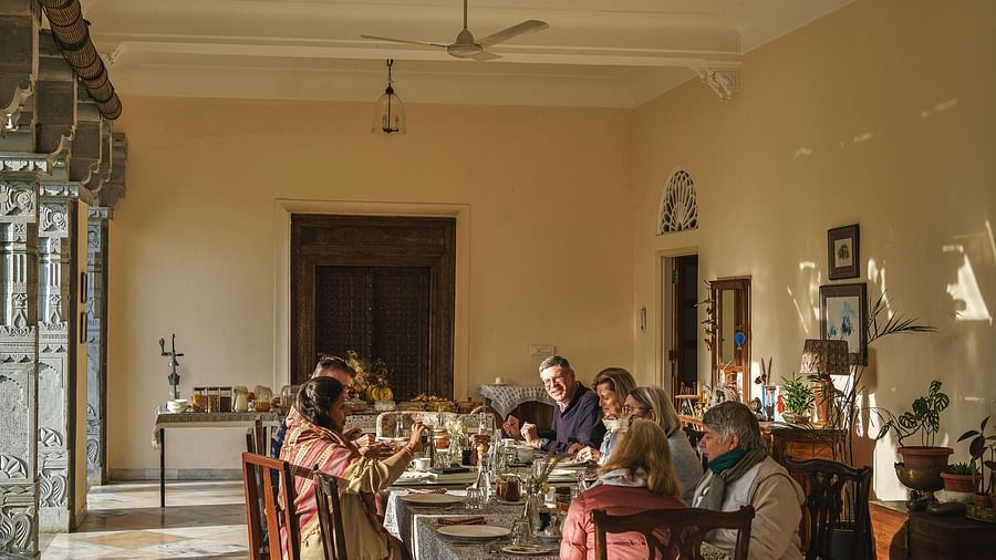 an image of people having food in the dining space at dev shree, deogarh