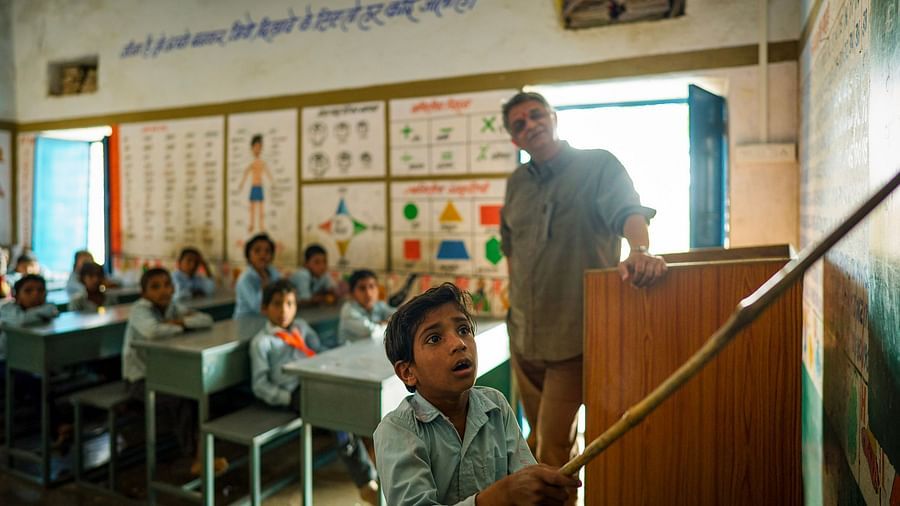 image of a todler pointing out at something with a stick in his hand as everyone behind him watches