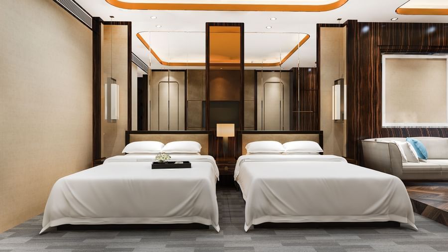 A spacious room featuring a twin bed, elegant lighting, wooden panelling, and contemporary interior design.