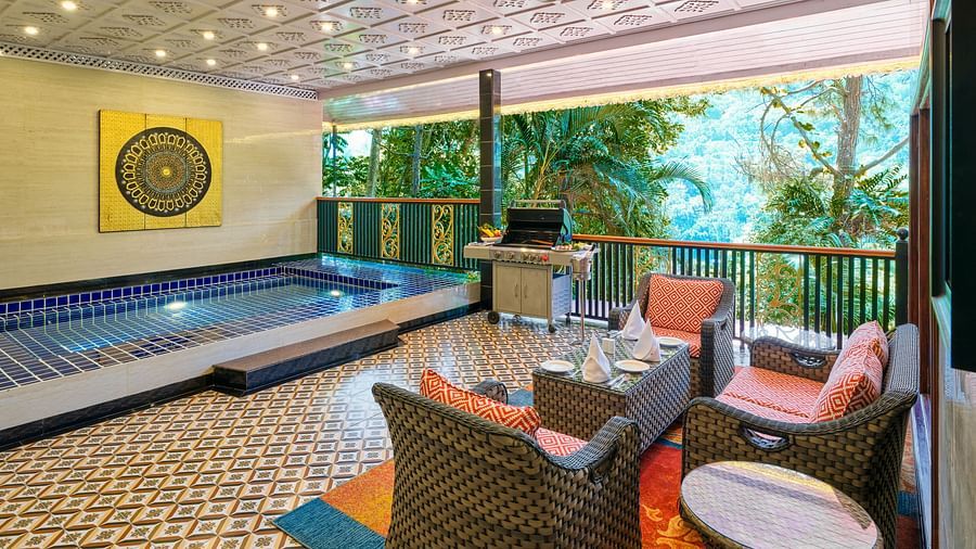 Crown Villa Pool with a seating area and a balcony overlooking greenery