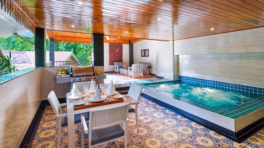 swimming pool in Oriental Villa with a dining area, barbeque grill and wooden ceiling