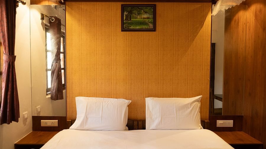Image of a bed with wooden headboard at 2bhk Studio Apartment, Vistar Holidays, Goa.