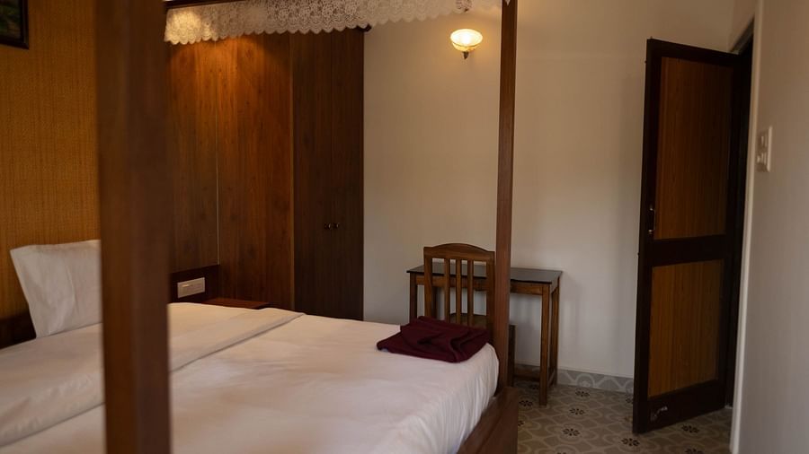 Image of a room with a bed and a table on the side at the 2 bhk Studio Apartment, Vistar Holidays, Goa.