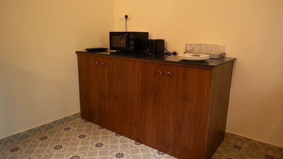 Image of a cupboard with utilities placed on top of it at Vistar Holidays, Goa.