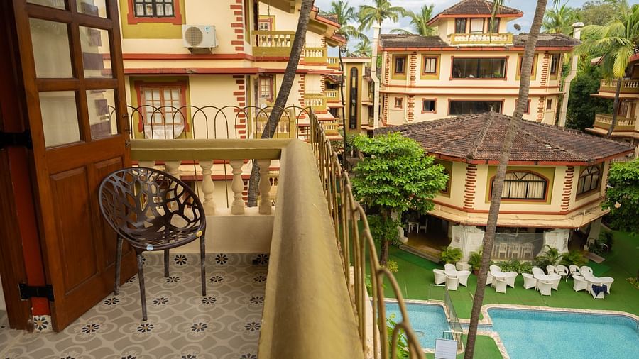 Image of a balcony overlooking the swimming pool at Vistar Holidays, Goa.