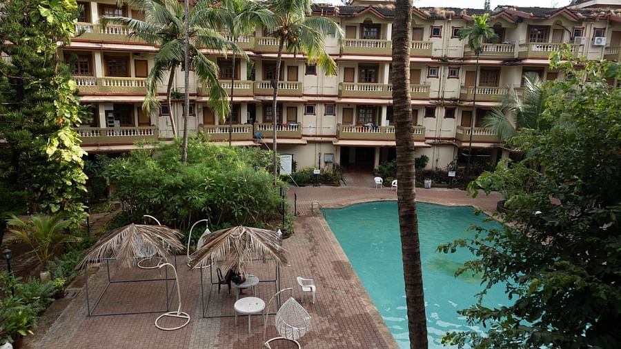 Facade of Vistar Holidays, Goa with a swimming pool in front.