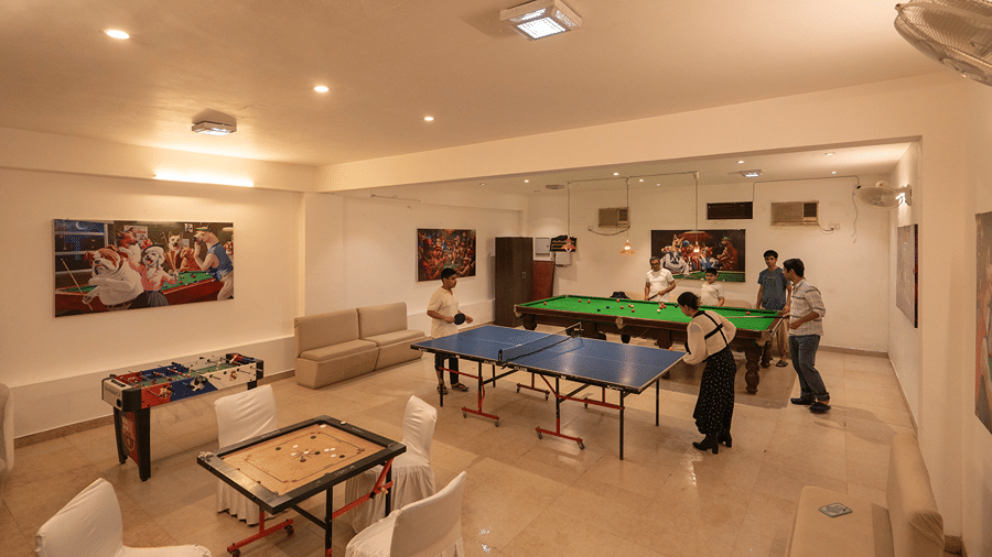 An indoor activity room featuring a table tennis table, carom board, and pool table for guest recreation - Wood Castle Spa & Resort, Jim Corbett