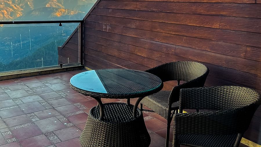Modern terrace seating area with stunning valley views at Aranya Retreat, perfect for sunrise coffee moments