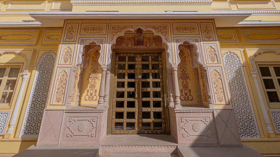 facade image of our hotel with sun rays illuminating the exterior - Brij Castle, Jaipur
