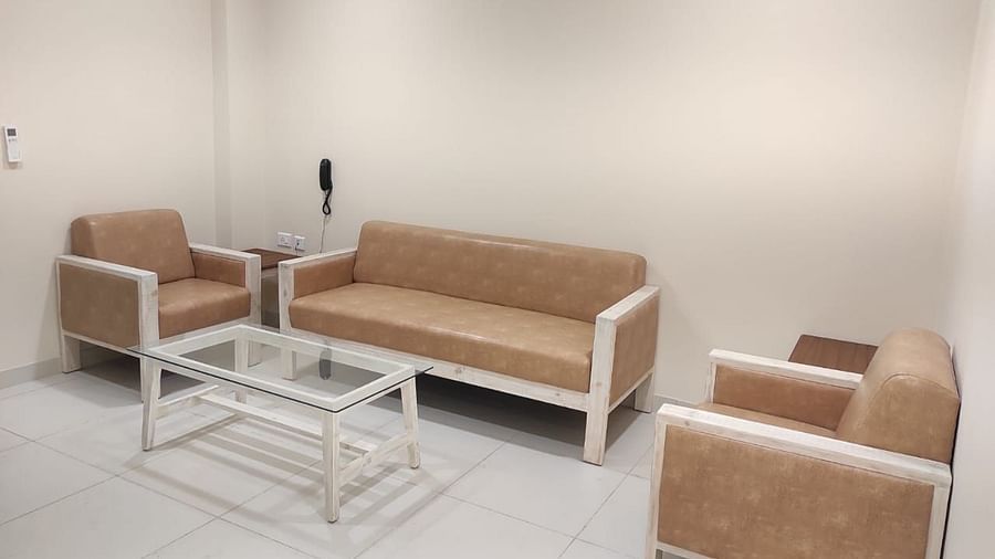 A living room with sofas and a table - A M Suites