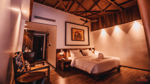 room with a king size bed decorated with wooden interiors and mellow lighting - Symphony Samudra Beachside Jungle Resort And Spa, Port Blair