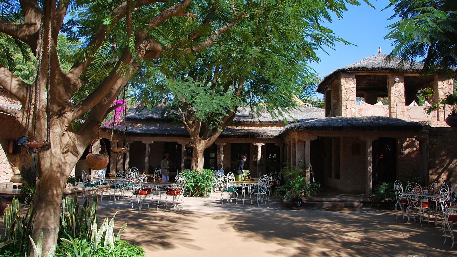 A facade image of the Taasli Restaurant at Manvar Shergarh with trees around it - Manvar Resort & Desert Camp