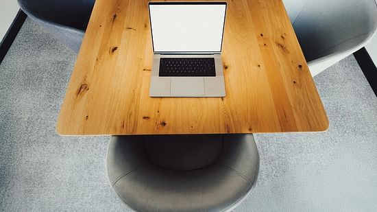 Shot of a laptop kept on a wooden table.
