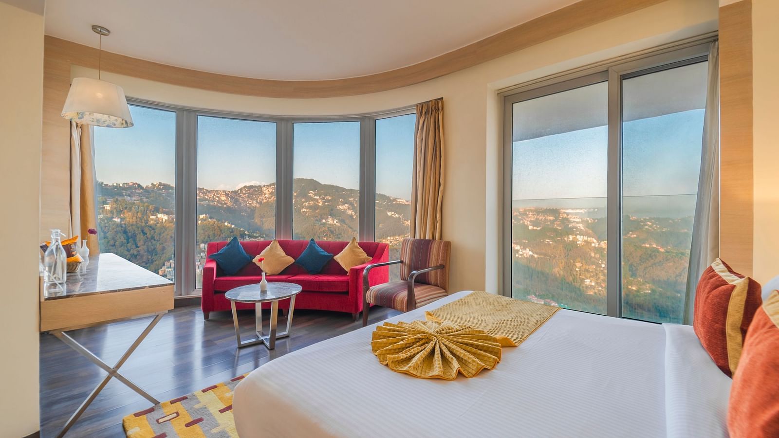 an image of a bedroom with huge french windows at the zion, shimla