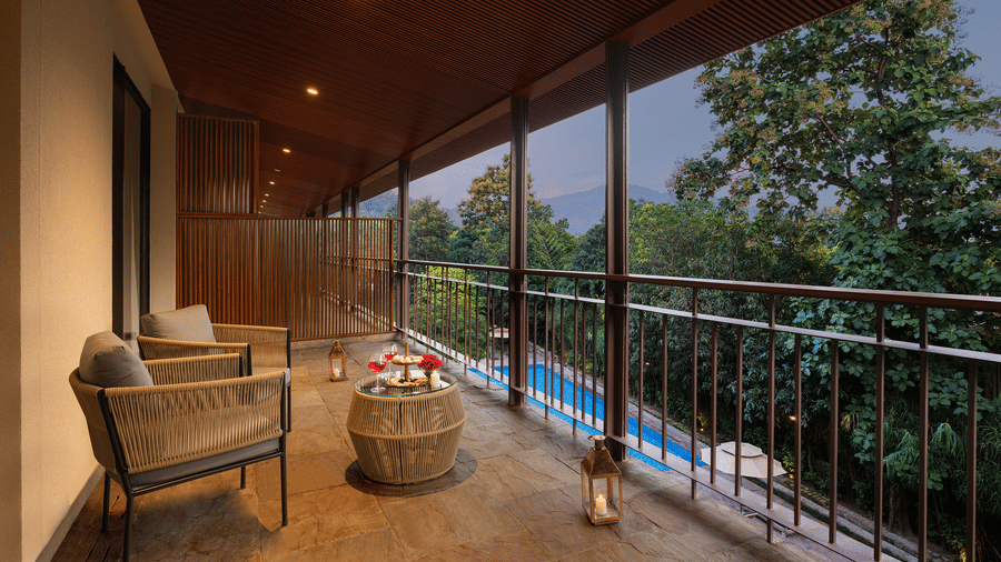 Private balcony seating area of a Sanctuary Suite at The Riverview Retreat, Corbett, overlooking the surrounding forest.