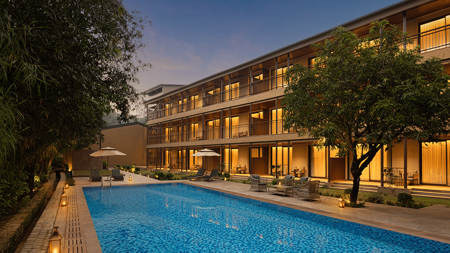 Swimming pool beside the resort building with guest room balconies at The Riverview Retreat, Corbett.