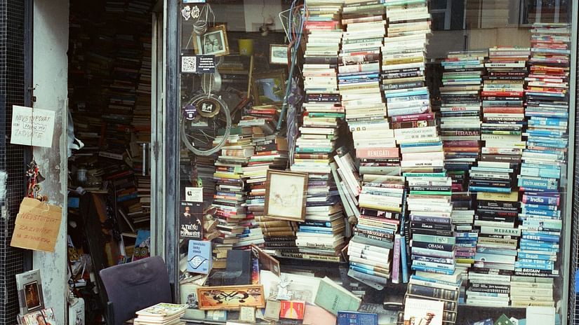 An overview of a second hand bookstore with many books stacked on top of each other