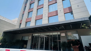 Exterior view of the Ramada Encore by Wyndham Chandigarh Zirakpur building captured from a lower angle, showing multiple floors and architectural structure.