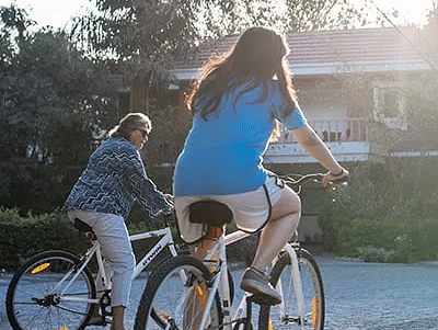 Women riding  bicycles near Karma Chalets.