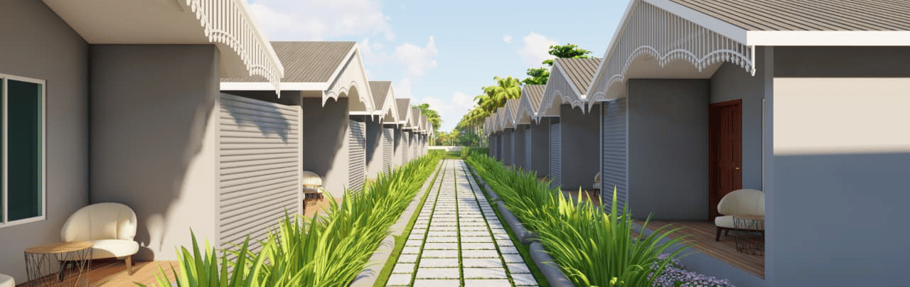 A walkway lined with plants separates two rows of houses with curved roofs at Trishvam Palolem Beach Resort, Goa.