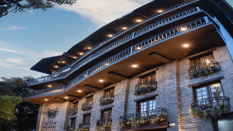 Shot of the facade of the hotel during the evening with a backdrop of blue sky.