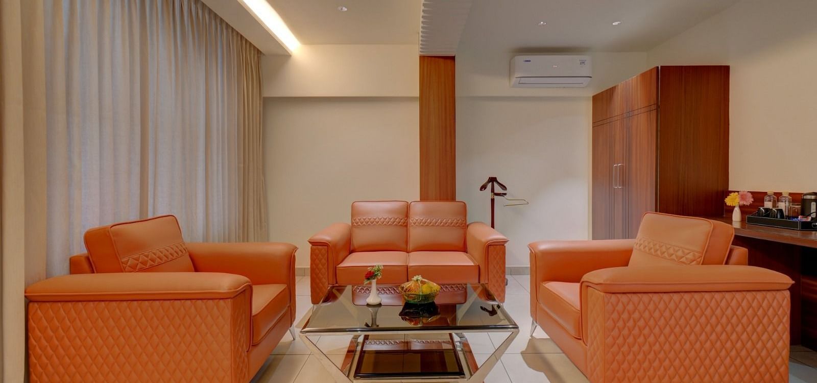 Image of a seating area with sofas and a table in the middle at Hari Govindas, Siddappa Square.