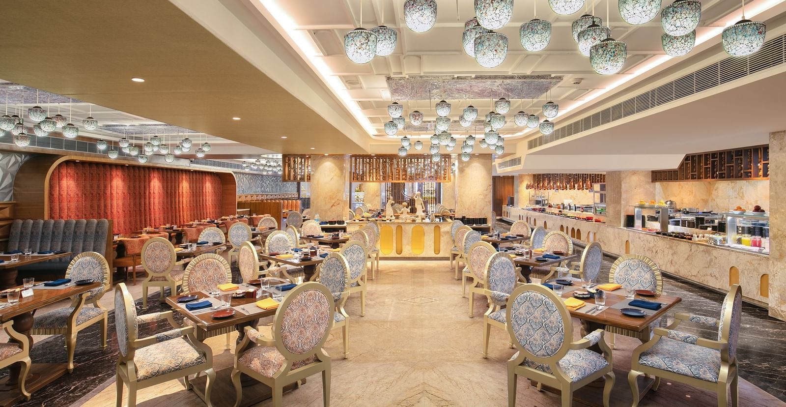 A spacious dining hall featuring modern decor and warm lighting - Kaldan Samudhra Palace