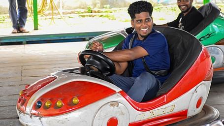 A man driving a dashing car in an arena at MGM Dizzee World.