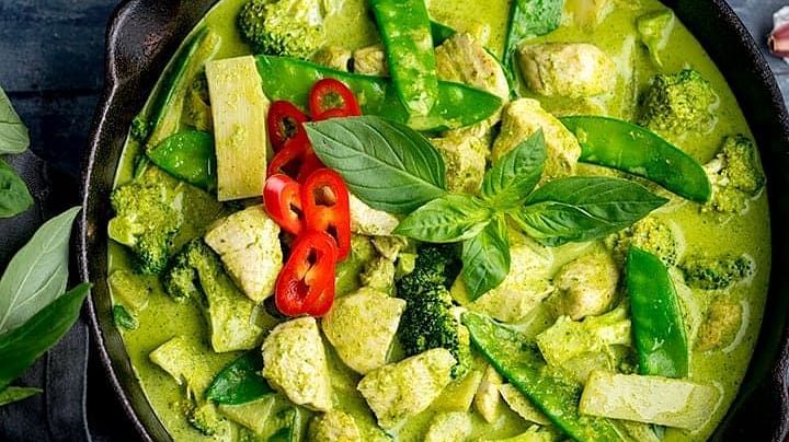 an aerial view of Green Curry in a bowl - Rhythm Lonavala