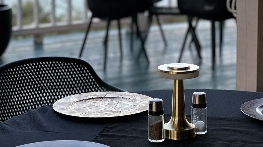 A table set with plates and cutlery overlooking ocean view | A Stone's Throw Away