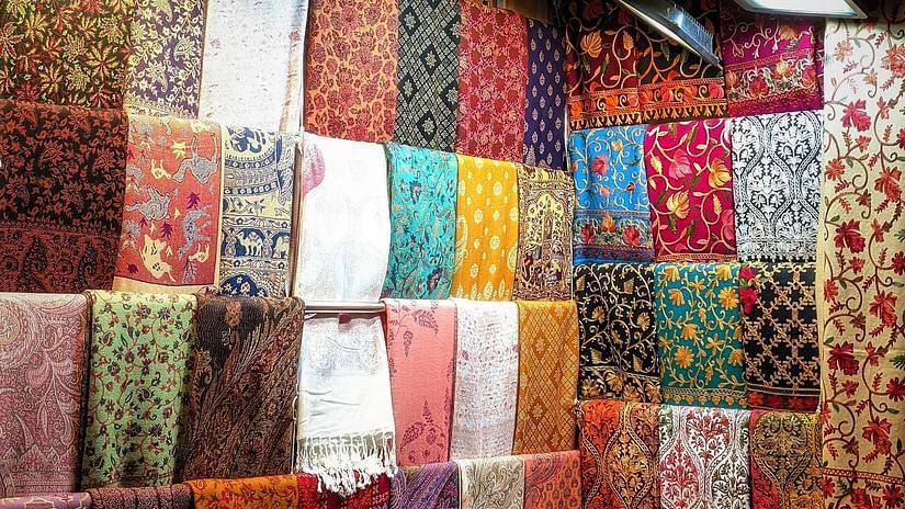Colorful handmade traditional fabrics on display in a shop.