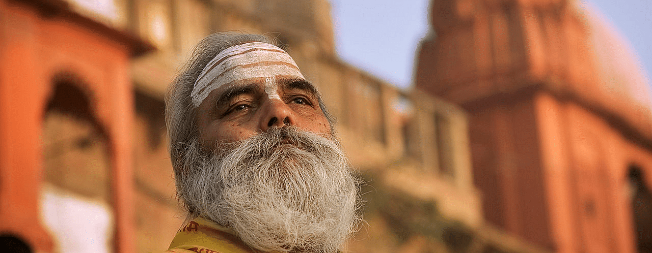 A close shot of a man with grey bread  - Ganga Lahari, Haridwar