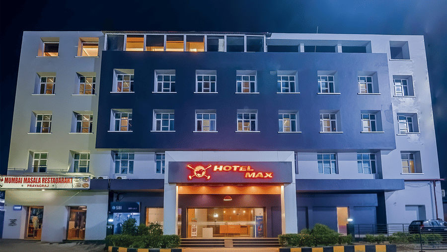 Exterior view of Max Hotel Prayagraj building with entrance at night.