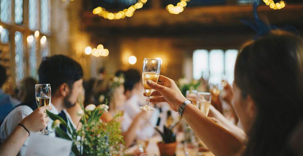 People raising a toast at a dinner table - Narrow Gauge Inn - A Serenite Hotel Near Fish Camp.